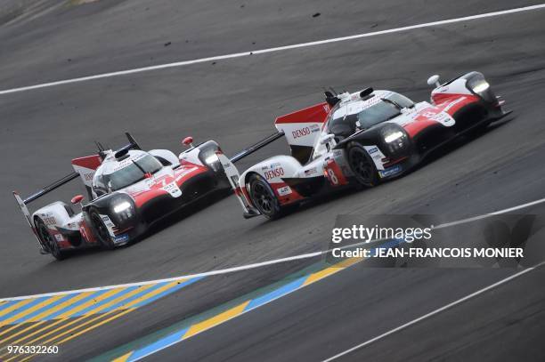 Toyota TS050 Hybrid LMP1 Spain's driver Fernando Alonso competes ahead of the Toyota TS050 Hybrid LMP1 driven by Argentine's Jose Maria Lopez during...