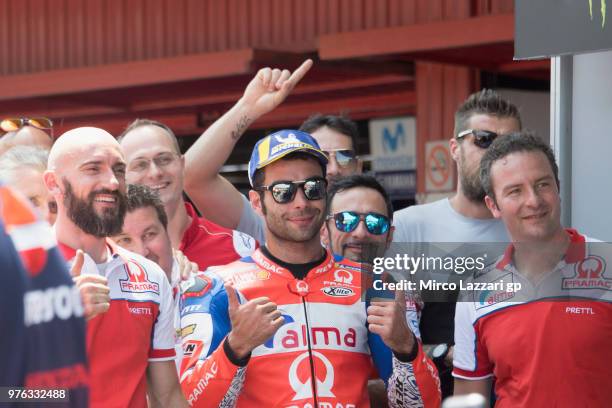 Danilo Petrucci of Italy and Alma Pramac Racing celebrates the Independent Team pole position with team at the end of the qualifying practice during...