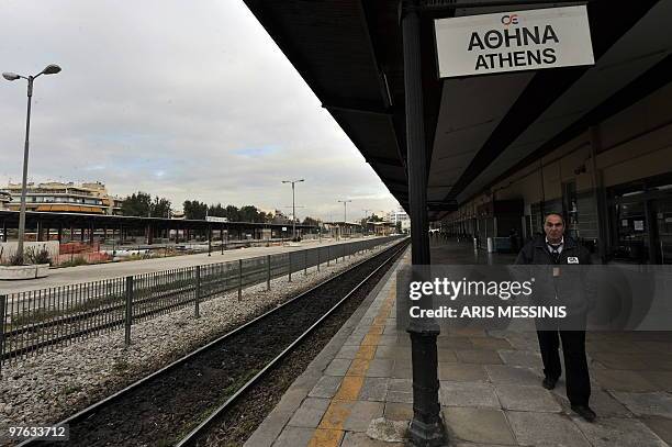 Security guard walks on the empty Athens' train station on March 11 2010, during the 24-hours general strike to protest the government's austerity...