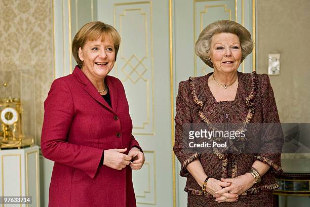 German Chancellor Angela Merkel is welcomed by Queen Beatrix at Huis ten Bosch Palace in The Hague during her one-day visit to the Netherlands on...