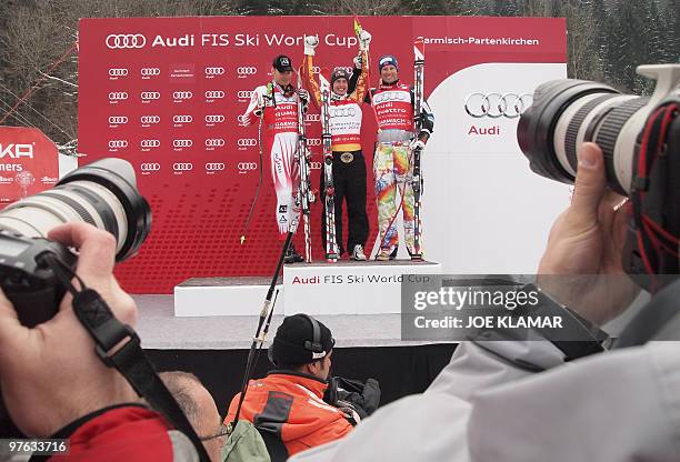 Overall winners, Second placed Austria's Michael Walchhofer, winner Canada's Erik Guay , and third placed Norway's Aksel Lund Svindal in the finish...