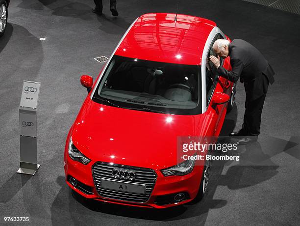 Visitor looks at an Audi A1 automobile on display during Volkswagen AG's annual earnings news conference in Wolfsburg, Germany, on Thursday, March...