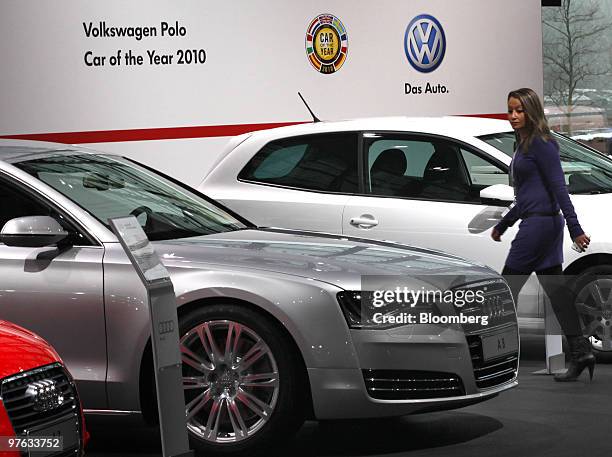 Volkswagen and Audi automobiles sit on display during the company's annual earnings news conference in Wolfsburg, Germany, on Thursday, March 11,...