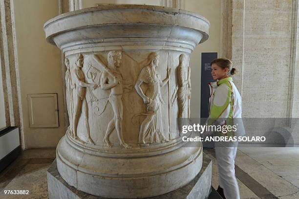 Visitor looks at a Puteal of the twelve gods, known as the Albani, during the presentation to the press of "L'Eta della conquista. Il fascino...