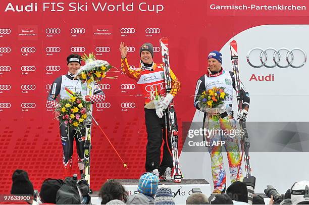 Second placed Croatia's Ivica Kostelic , winner Canada's Erik Guay , and third placed Norway's Aksel Lund Svindal pose in the finish area after the...