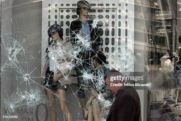 Storefront windows are left damaged in the wake of violent protesters on March 11, 2010 in Athens, Greece. A 24-hour general strike is being held to...