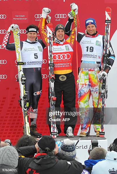 Second placed Croatia's Ivica Kostelic , winner Canada's Erik Guay , and third placed Norway's Aksel Lund Svindal pose in the finish area after the...