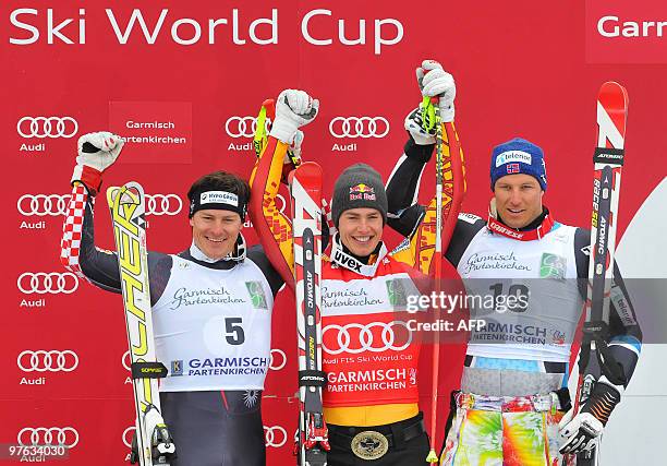 Second placed Croatia's Ivica Kostelic , winner Canada's Erik Guay , and third placed Norway's Aksel Lund Svindal pose in the finish area after the...