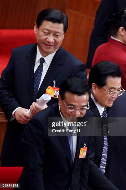 China's President Hu Jintao and Vice-Premier Li Keqiang shake hands with delegates as Vice President Xi Jinping passing after the fourth plenary...