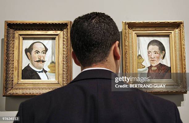 Man looks at paintings of French artist Le Douanier-Rousseau 09 March 2006 at the Grand Palais museum in Paris before the opening of the exhibition...