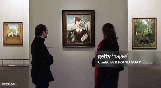 People look at "Portrait de Monsieur X " of French artist Le Douanier-Rousseau 09 March 2006 at the Grand Palais museum in Paris before the opening...