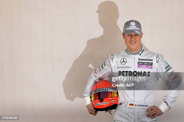 Mercedes GP's German driver Michael Schumacher poses for photographers at the Bahrain international circuit on March 11, 2010 in Manama, three days...