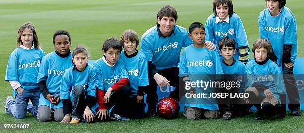 Barcelona's Argentinian forward Lionel Messi poses with children after being appointed UNICEF goodwill ambassador at the Camp Nou Stadium in...