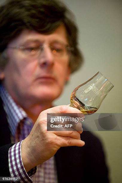 Man holds a glass containing what is believed to be the world�s oldest bottled single malt whisky as it is launched at Edinburgh Castle, in Scotland,...
