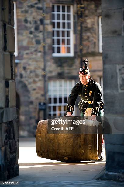 Soldier pushes a barrell containing what is believed to be the world�s oldest bottled single malt whisky as it is launched at Edinburgh Castle, in...