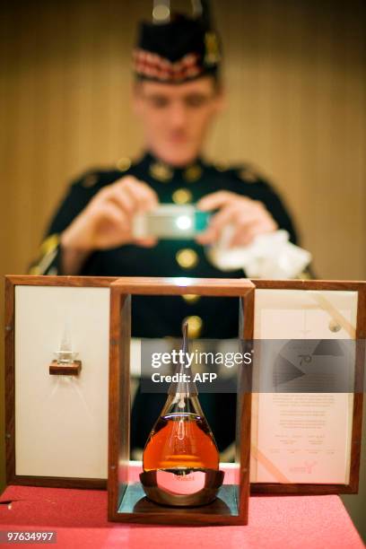 Man takes a picture of what is believed to be the world�s oldest bottled single malt whisky as it is launched at Edinburgh Castle, in Scotland, on...