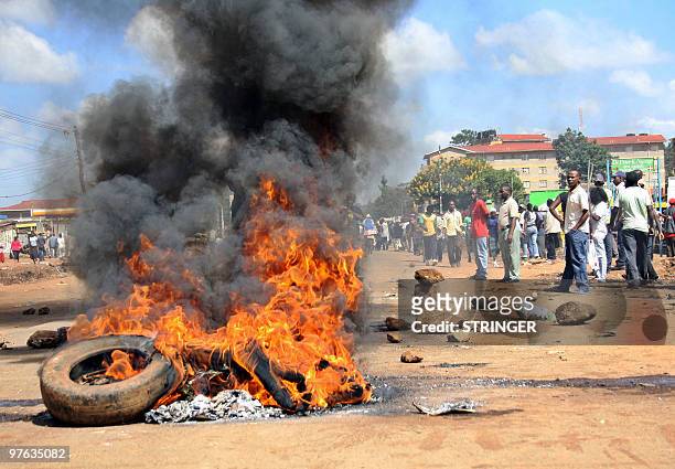 Residents of Kawangware burn tires on the main road on March 11, 2010 to protest the killing of seven suspected members of the infamous Kenyan sect...
