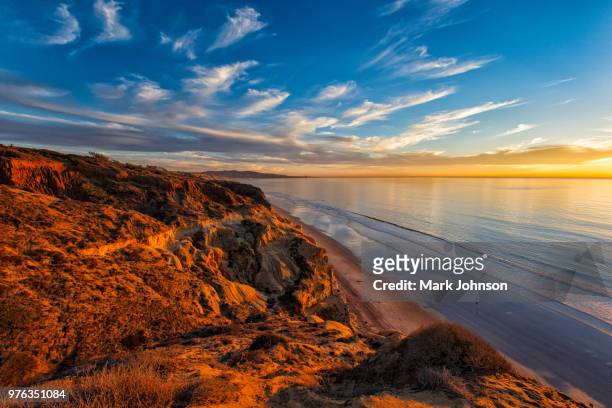 sunset over beach, torrey pines state natural reserve, san diego, california, usa - san diego stock pictures, royalty-free photos & images