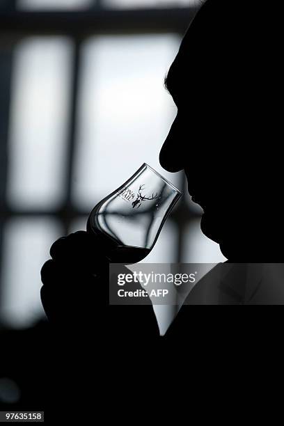 Man holds a glass containing what is believed to be the world�s oldest bottled single malt whisky as it is launched at Edinburgh Castle, in Scotland,...