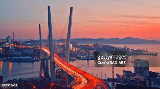 golden bridge in sunset, vladivostok, russia - vladivostok stock pictures, royalty-free photos & images