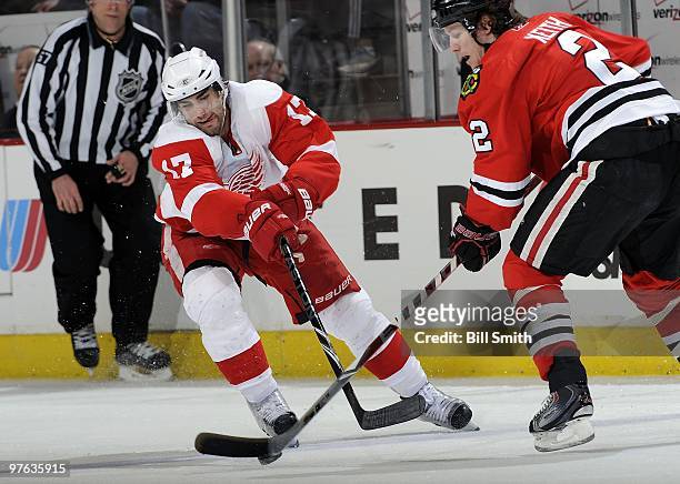 Patrick Eaves of the Detroit Red Wings gets ready to steal the puck away from Duncan Keith of the Chicago Blackhawks on March 07, 2010 at the United...