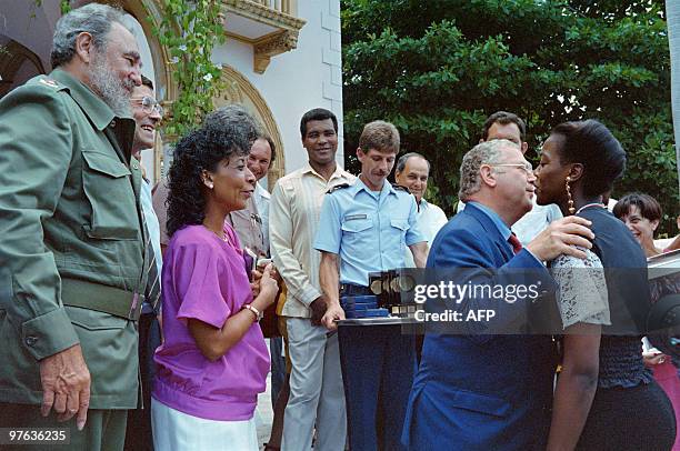 Cuban President Fidel Castro watches as french Budget Minister Michel Charasse presents awards in Cuba on August 22, 1992 to Cuban athletes who won...