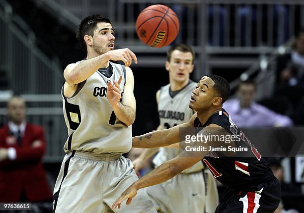 Nate Tomlinson of the Colorado Buffaloes passes the ball over John Roberson of the Texas Tech Red Raiders in the second half during the first round...