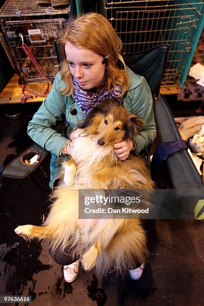 Woman and his dog wait by the practice arena on day one of the annual Crufts dog show at the National Exhibition Centre on March 11, 2010 in...