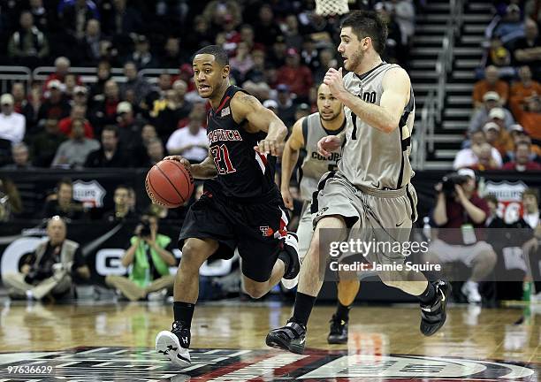 John Roberson of the Texas Tech Red Raiders moves the ball against Nate Tomlinson of the Colorado Buffaloes in the second half during the first round...