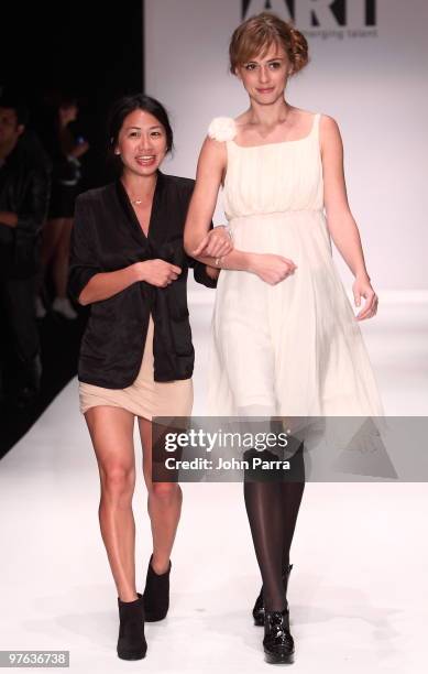 Stephanie Tran and model walk the runway at the Duskin show during the Gen Art 6th Annual Fresh Faces in Fashion Show during the opening of...