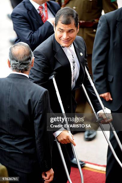 Ecuador's President Rafael Correa, using crutches, arrives at the National Congress in Valparaiso to attend new President Sebastian Pinera...