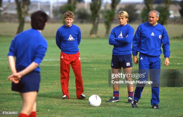 Chelsea coach Ernie Walley with players Micky Hazard and John Bumstead during a training session held in 1985 at Harlington, in London, England.