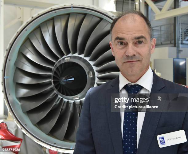 June 2018, Germany, Dahlewitz: Warren East, CEO of Rolls-Royce, standing before a newly developed and finished business-jet engine Pearl 15 during a...