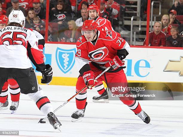 Patrick Dwyer of the Carolina Hurricanes skates with the puck during a NHL game against the Ottawa Senators on March 4, 2010 at RBC Center in...