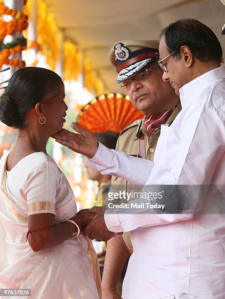 Union Home Minister P Chidambaram consoles a widow of a CISF martyr at the 41st raising day parade of the CISF in New Delhi on March 10, 2010.