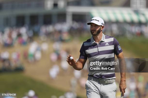 Dustin Johnson of the United States waves on the first green during the third round of the 2018 U.S. Open at Shinnecock Hills Golf Club on June 16,...