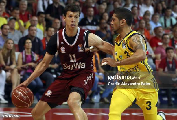 Vladimir Lucic of FC Bayern Muenchen competes with Peyton Siva of Alba Berlin during the fifth and final play-off game of the German Basketball...