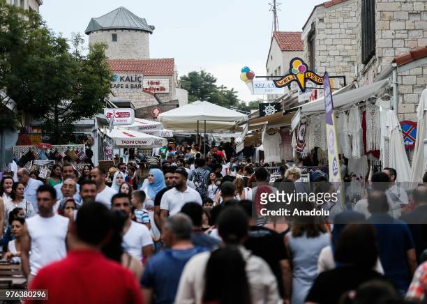 People pass the time at historic and touristic streets of Alacati neighborhood on a summer day at Cesme district, during the Eid al-Fitr in Izmir,...