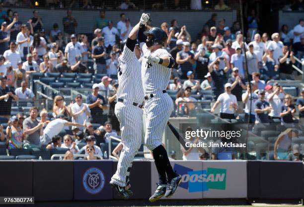 Giancarlo Stanton of the New York Yankees celebrates his fifth inning home run against the Tampa Bay Rays with teammate Gary Sanchez at Yankee...