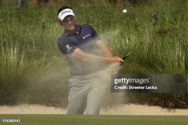 Ian Poulter of England plays a shot from a bunker on the third hole during the third round of the 2018 U.S. Open at Shinnecock Hills Golf Club on...