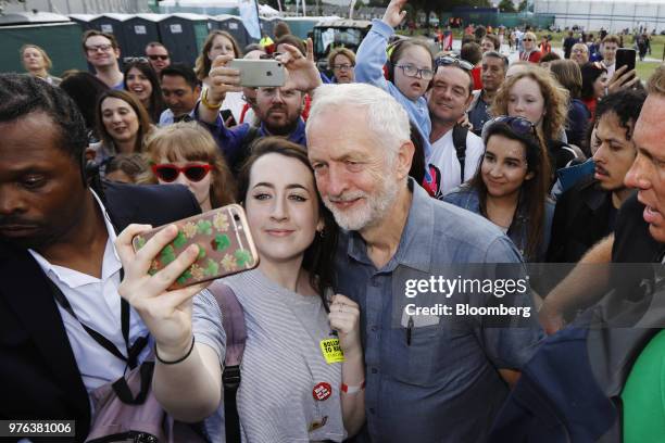 Jeremy Corbyn, leader of the U.K's opposition Labour Party, center right, takes a selfie photograph with an attendee at the 'Labour Live' festival in...