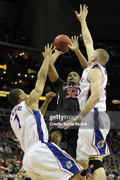 Mike Singletary of the Texas Tech Red Raiders shoots the ball over Xavier Henry and Cole Aldrich of the Kansas Jayhawks in the first half during the...