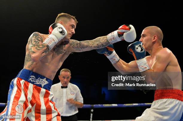 Ricky Burns , takes on Ivan Njegac red white and blue shorts), during the Super-Lightweight contest presented by Matchroom Boxing at Metro Radio...