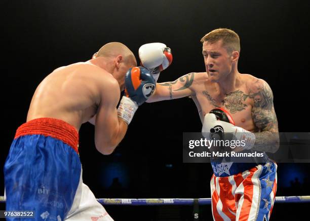 Ricky Burns , takes on Ivan Njegac red white and blue shorts), during the Super-Lightweight contest presented by Matchroom Boxing at Metro Radio...