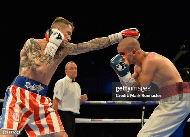 Ricky Burns , takes on Ivan Njegac red white and blue shorts), during the Super-Lightweight contest presented by Matchroom Boxing at Metro Radio...