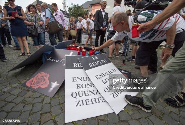 June 2018, Germany, Mainz: A few dozen people gather at a vigil organised by the Alternative for Germany to commemorate 14-year-old murder victim...