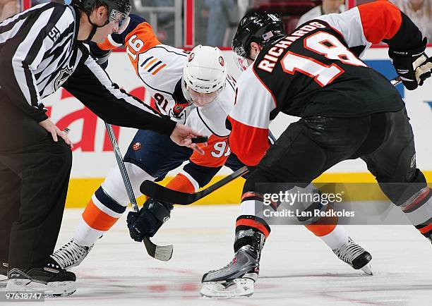 Linesman Shane Heyer readies to drop the puck on a face-off between Mike Richards of the Philadelphia Flyers and John Tavares of the New York...