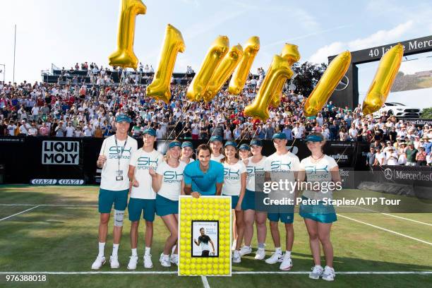 Roger Federer of Switzerland and the ball kids with a presentation for regaining the world number one title after his Semi-Finals match win against...