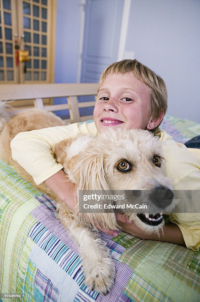 Girl on bed with dog