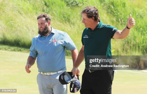 Andrew 'Beef' Johnston of England and Phil Mickelson of the United States acknowledge the crowd on the 18th green during the third round of the 2018...